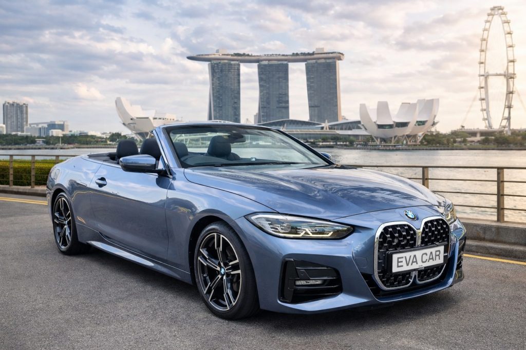 Blue BMW 4 Series convertible at Marina Bay, part of the Eva Car Rental Singapore fleet.