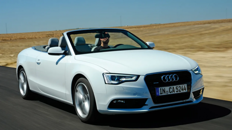 White Audi A5 Cabriolet with the roof down on an open road during a proposal sports car rental Singapore drive