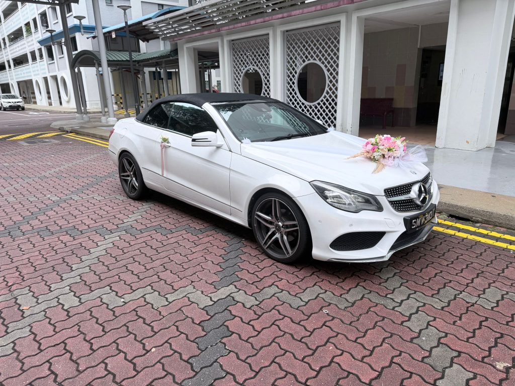 Decorated Mercedes E-Class cabriolet prepared for a wedding car rental Singapore schedule and bridal send-off.