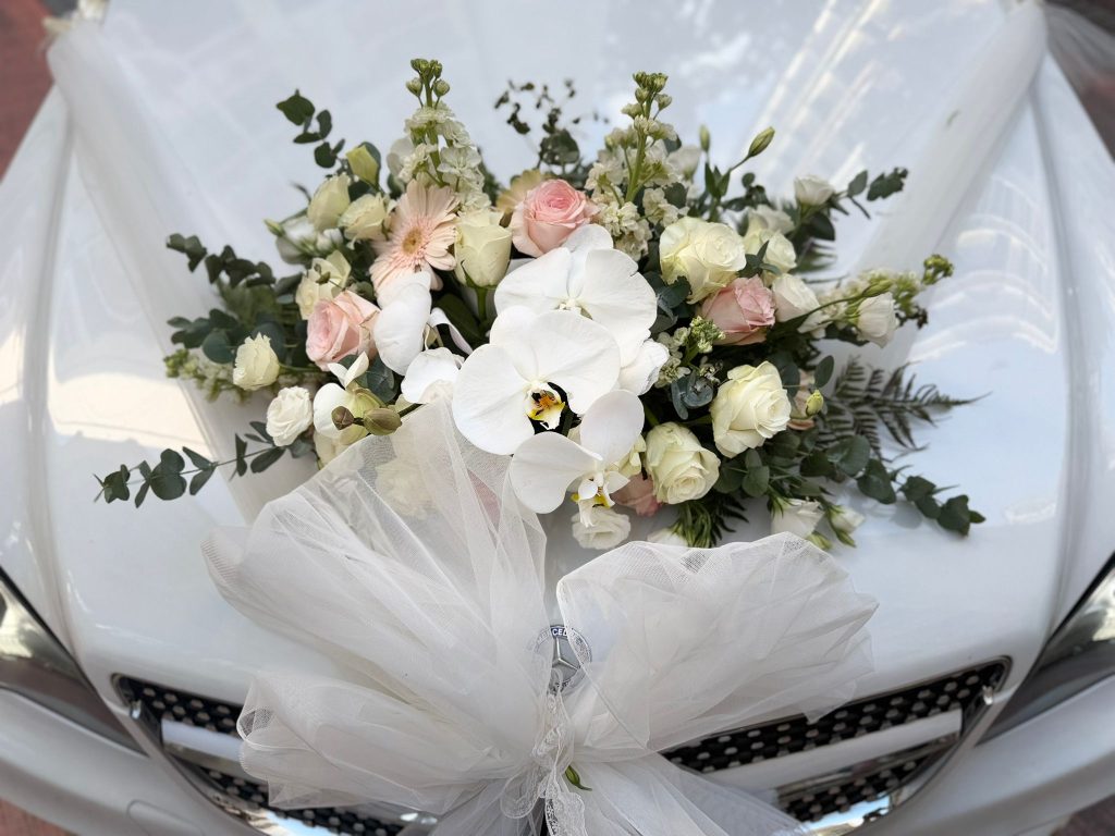 Rose and orchid bonnet floral decoration included in bridal car packages Singapore florists prepare