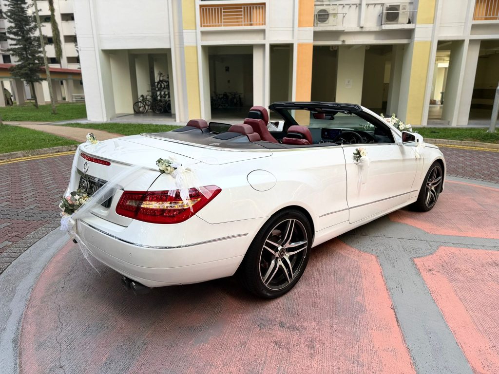 Rear view of a white Mercedes cabriolet after a hotel wedding car rental Singapore banquet arrival
