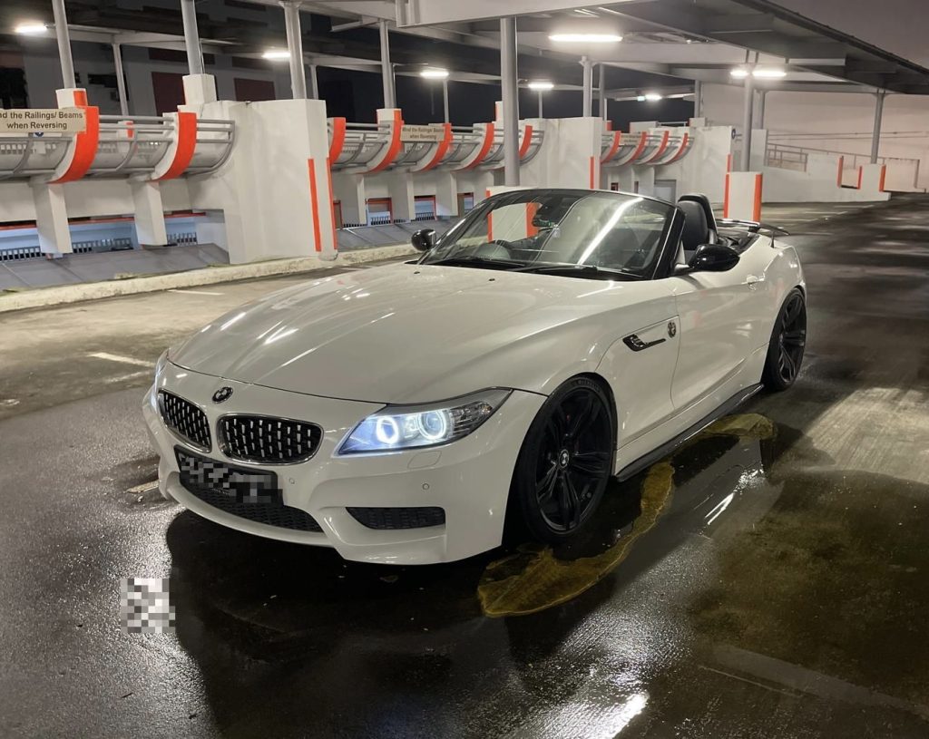 White BMW Z4 sDrive two-seater parked at night, ready for a proposal sports car rental Singapore drive